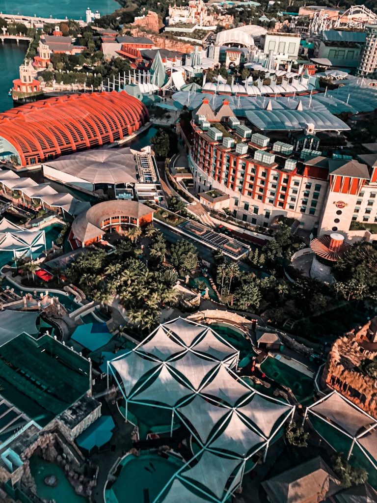 Photo by Nayan Bhalotia aerial view of green and white stadium during daytime