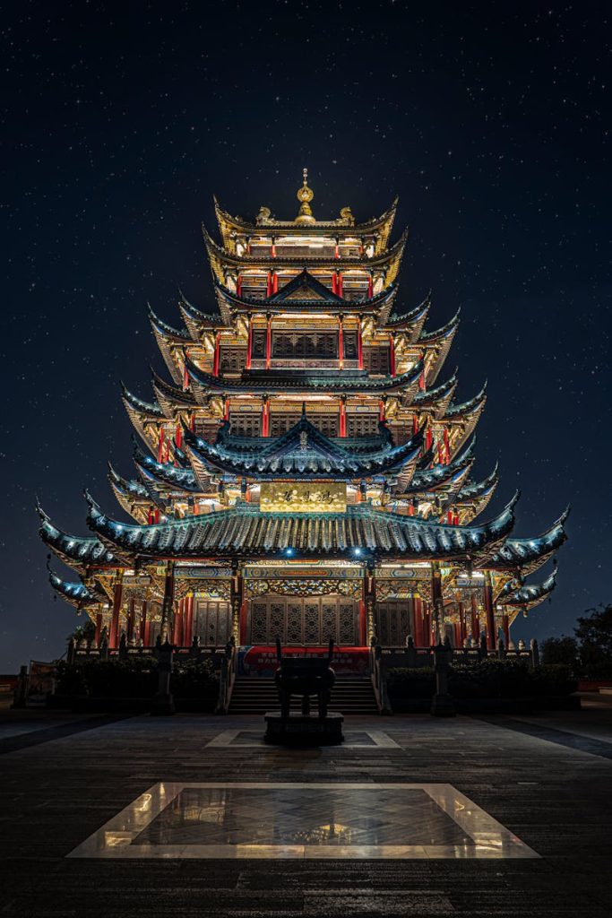 Photo by Ruiyang Zhang Blue, Yellow, and Green Lighted Pagoda Tower