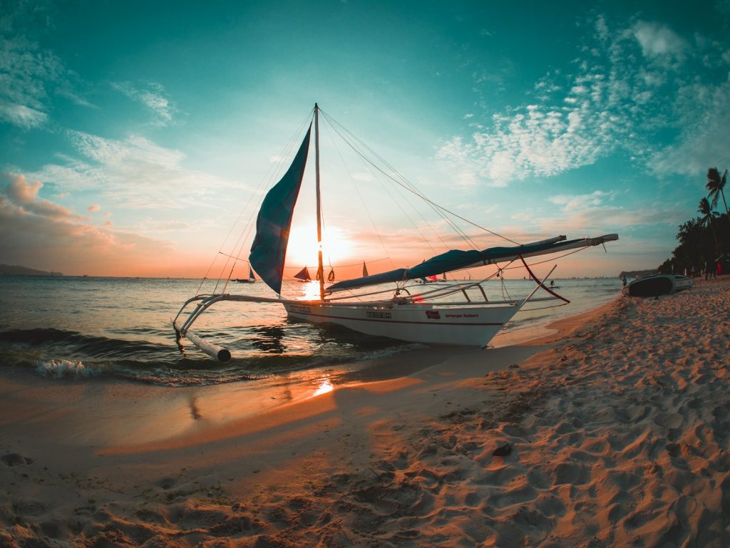 Photo by Ramon Kagie white boat docked on seashore