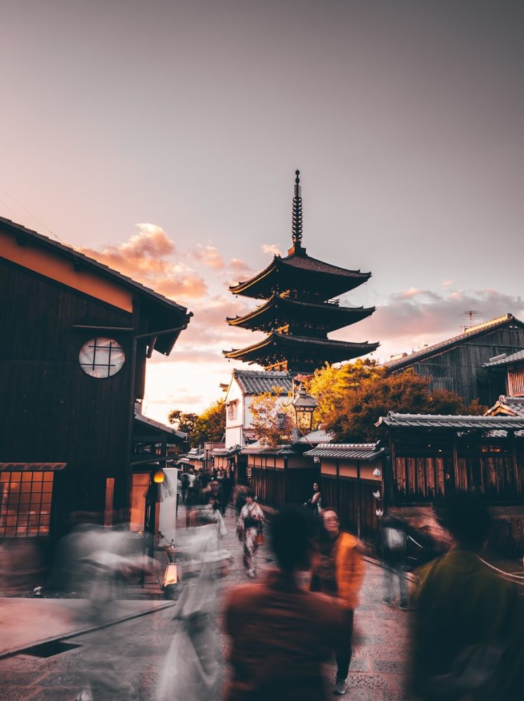 Photo by Fahrul Azmi people walking on street near brown wooden building during daytime