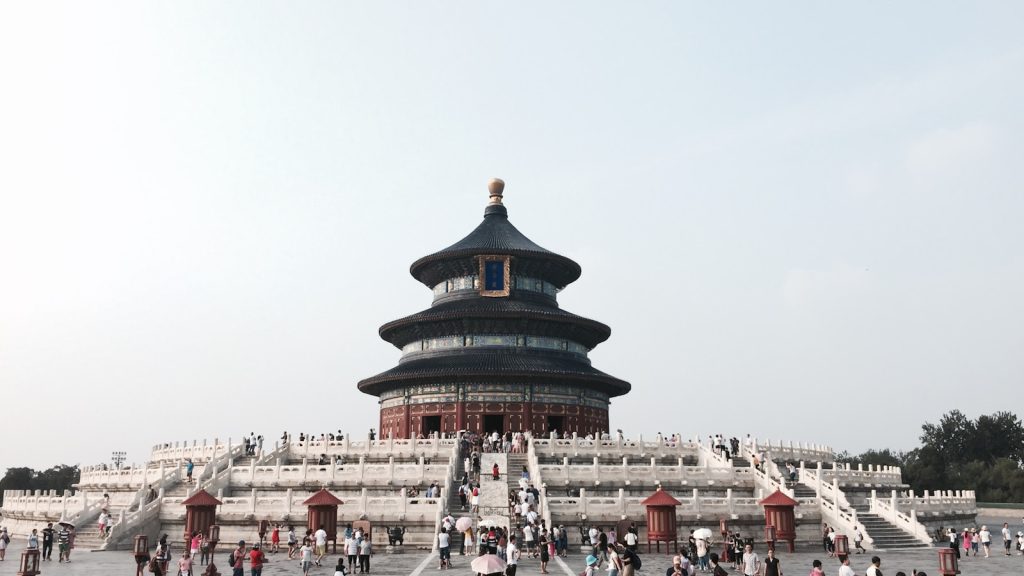 Photo by Ayrton Tang brown and white temple under clear blue sky