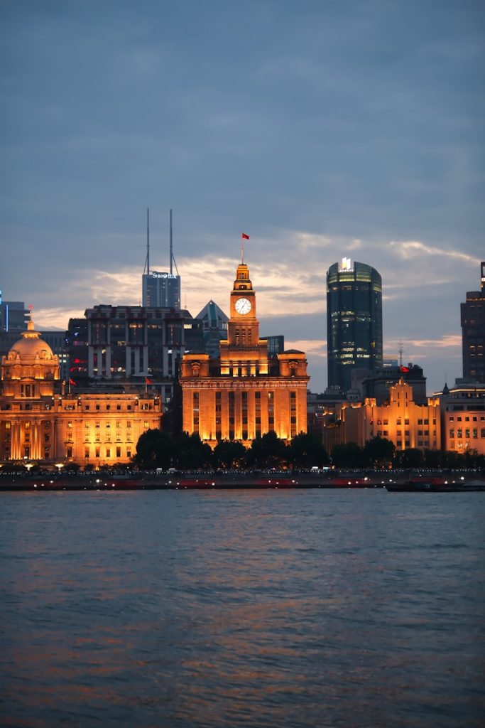 Photo by Zizhou Shi A large body of water with a city in the background