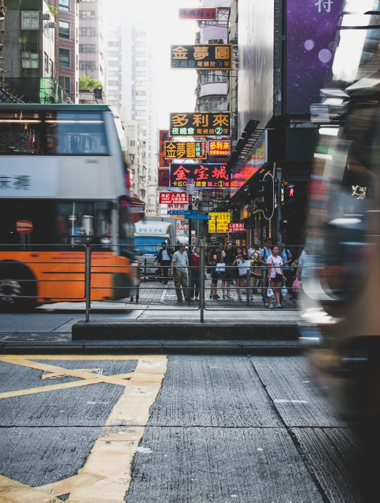 Photo by Richard Lee people standing in front road near buildings