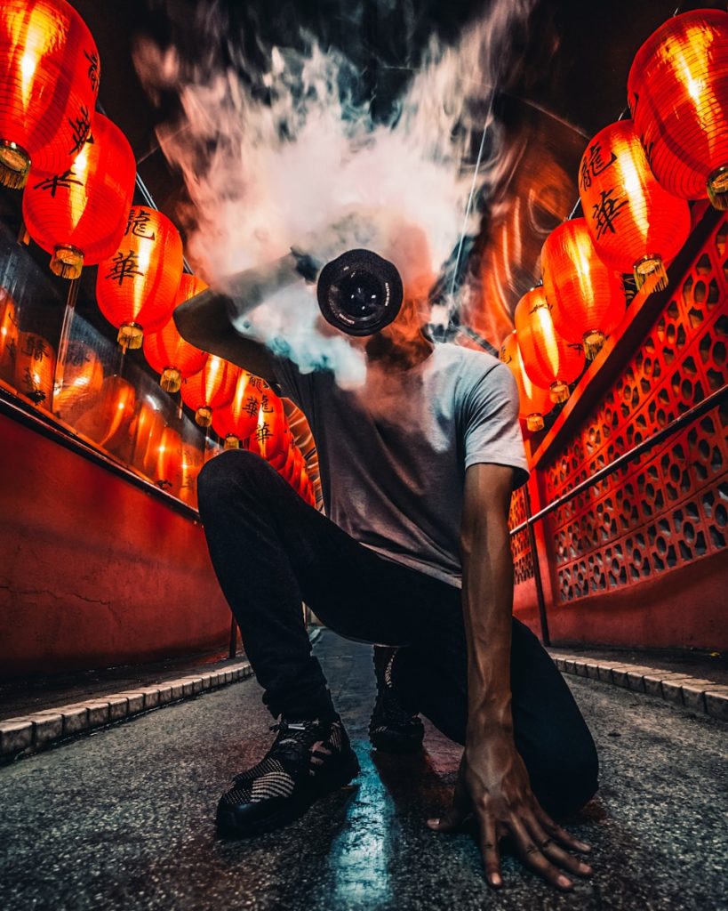 Photo by Simon Zhu person holding incense