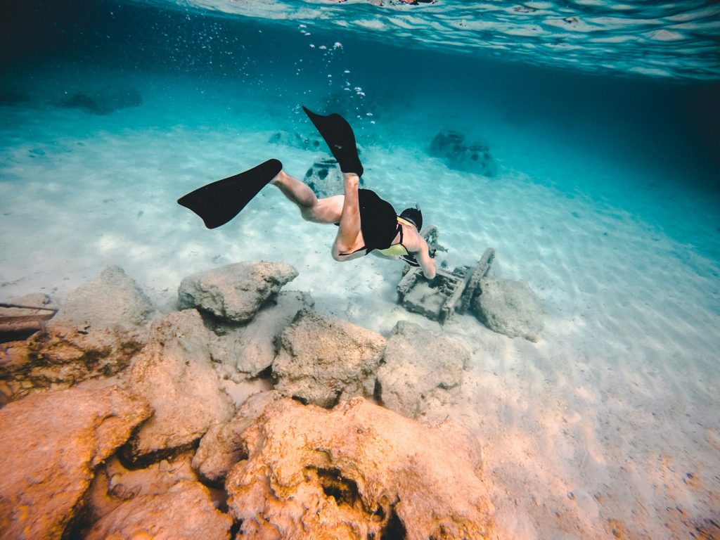 Photo by Jakob Owens person wearing diving suit underwater shallow focus photography
