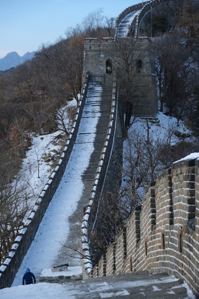 Photo by Pikacent a man walking up a snow covered hill