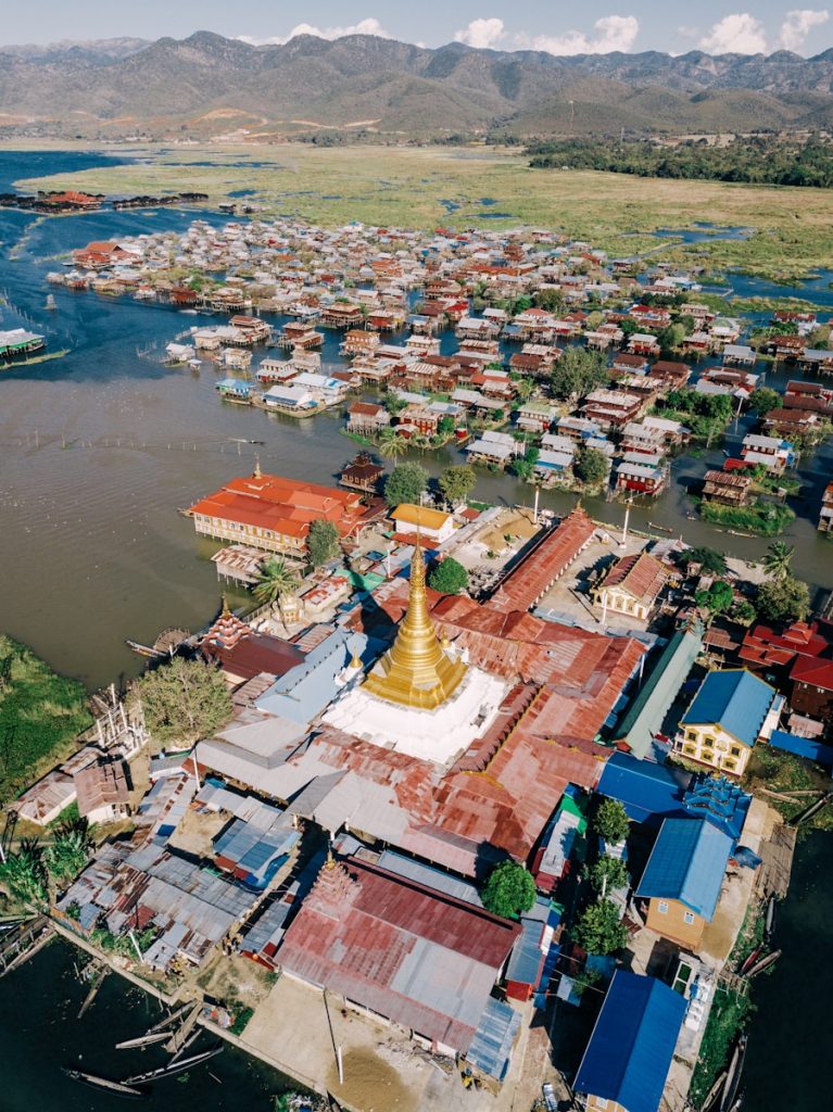 Photo by Alexey Komissarov An aerial view of a village with a river running through it
