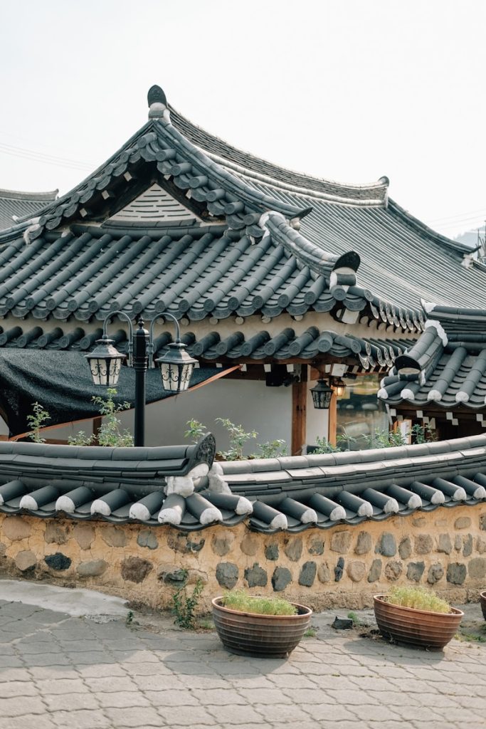 Photo by insung yoon a building that has a lot of roof tiles on it