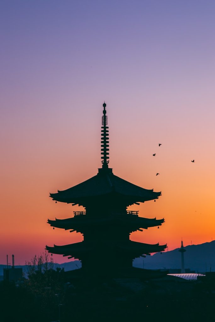 Photo by Ash Edmonds silhouette photo of pagoda