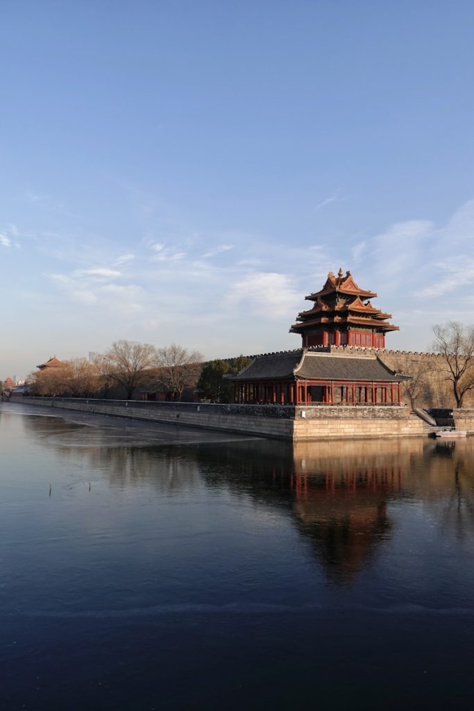 Photo by Nakaharu Line brown and black house near body of water under blue sky during daytime