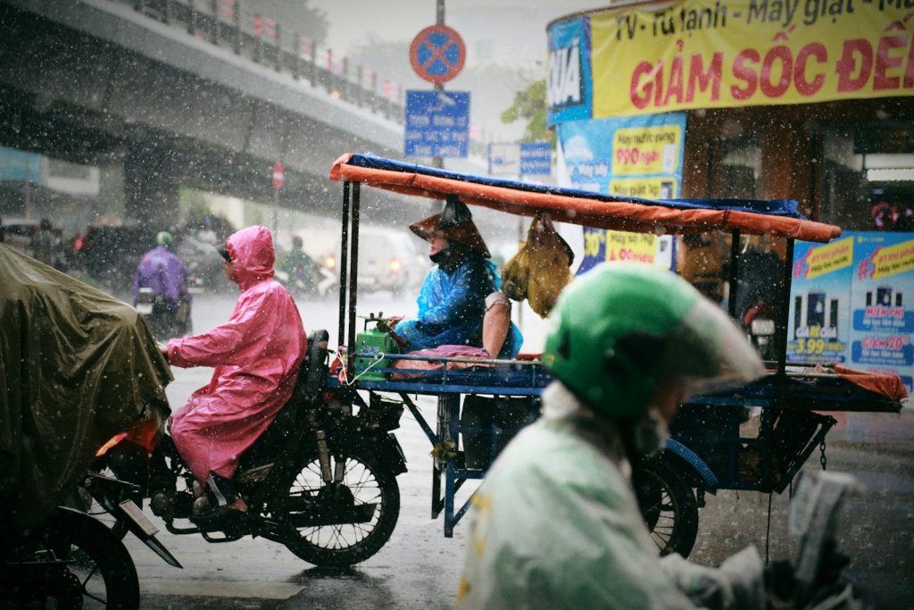 Photo by Minh Triet a group of people riding on the back of a motorcycle